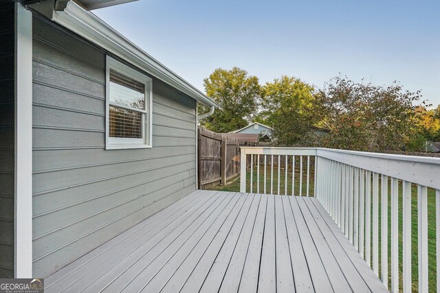 deck featuring a yard and fence