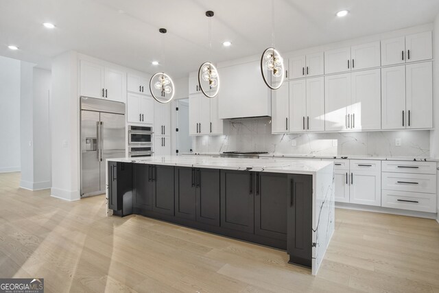 kitchen with white cabinets, light wood-type flooring, and appliances with stainless steel finishes