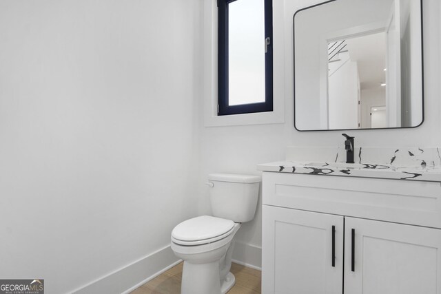 bathroom with toilet and vanity