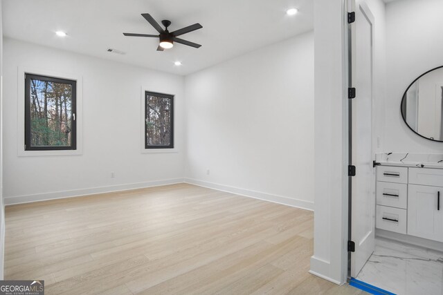 interior space with ceiling fan and light hardwood / wood-style floors