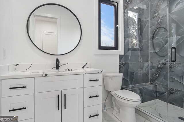 bathroom with toilet, vanity, and an enclosed shower