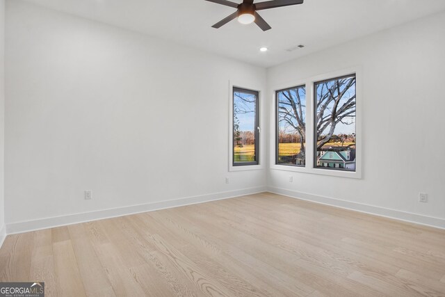 unfurnished room with ceiling fan and light wood-type flooring