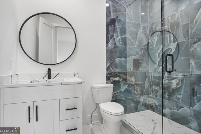 bathroom with toilet, a shower with shower door, and vanity