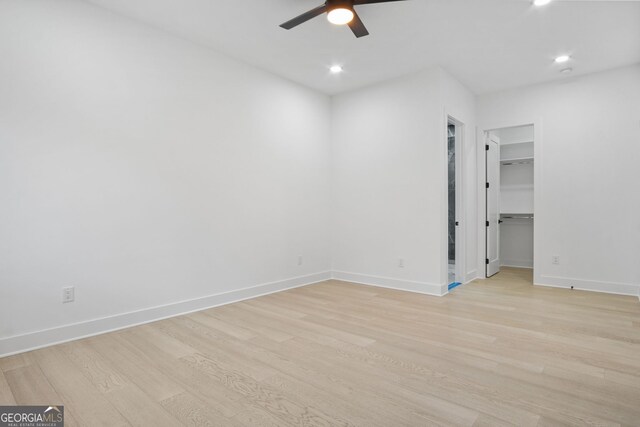 empty room featuring light wood-type flooring and ceiling fan