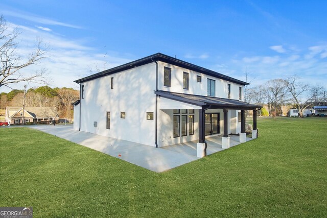 back of house featuring a yard and a patio