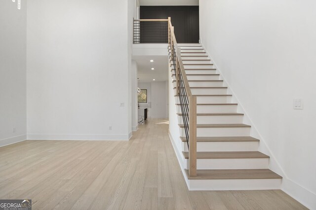 stairs with hardwood / wood-style floors