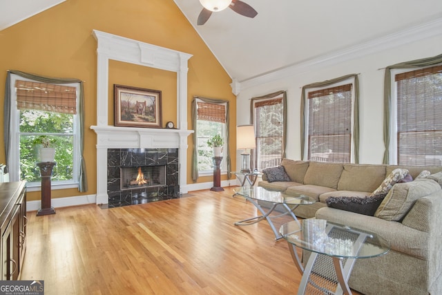 1565 Mountain Shadow Trl, Stone Mountain, GA 30087 - living area with a ceiling fan, a premium fireplace, baseboards, light wood-style flooring, and high vaulted ceiling