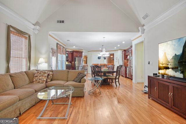 living room featuring light wood-type flooring, crown molding, a chandelier, and high vaulted ceiling