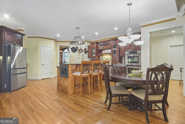 1565 Mountain Shadow Trl, Stone Mountain, GA 30087 - dining area featuring light wood finished floors, baseboards, ornamental molding, and an inviting chandelier