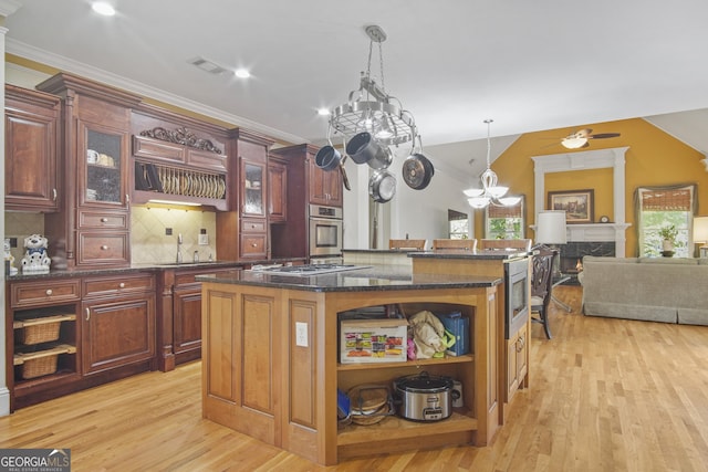 1565 Mountain Shadow Trl, Stone Mountain, GA 30087 - kitchen with open shelves, light wood-style floors, appliances with stainless steel finishes, and a center island