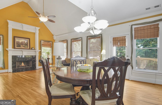1565 Mountain Shadow Trl, Stone Mountain, GA 30087 - dining space featuring vaulted ceiling, visible vents, a wealth of natural light, and ceiling fan with notable chandelier