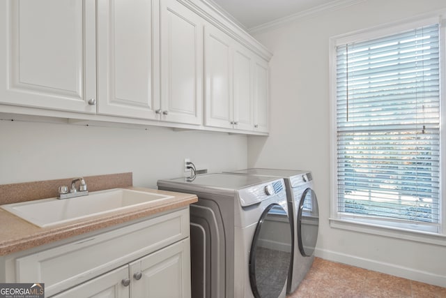 washroom with plenty of natural light, crown molding, sink, and washer and clothes dryer