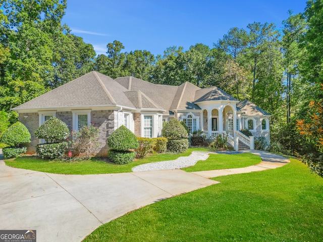 view of front of house with a front yard and a porch