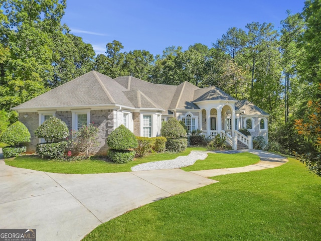 1565 Mountain Shadow Trl, Stone Mountain, GA 30087 - view of front of property with brick siding, a shingled roof, and a front yard