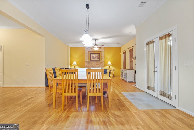 dining room featuring crown molding, light wood-type flooring, and ceiling fan