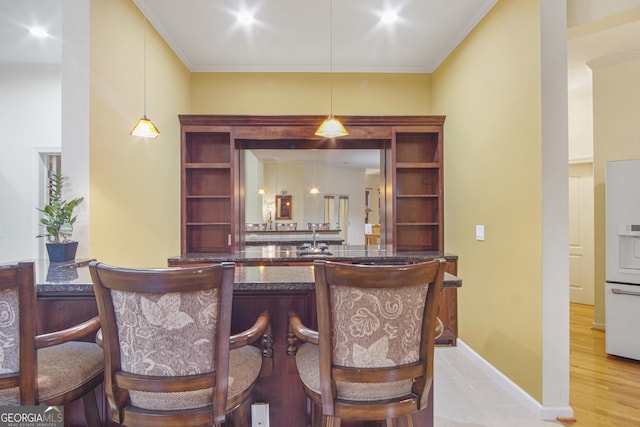 1565 Mountain Shadow Trl, Stone Mountain, GA 30087 - bar featuring decorative light fixtures, crown molding, a sink, and white refrigerator with ice dispenser