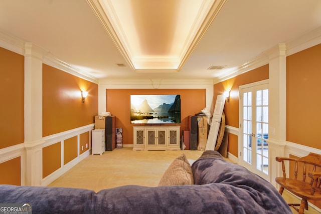 cinema with crown molding, french doors, and light colored carpet