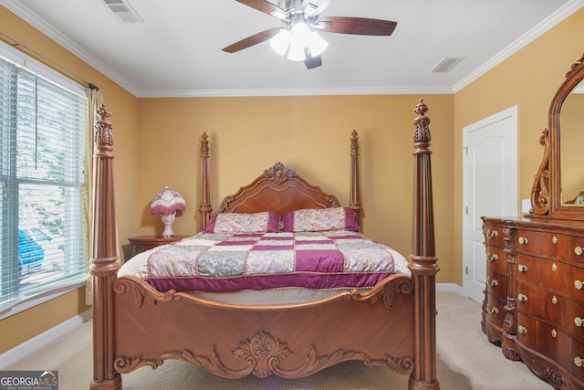 carpeted bedroom with ceiling fan and ornamental molding