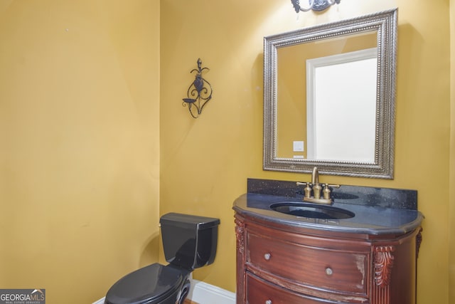 bathroom with toilet and vanity