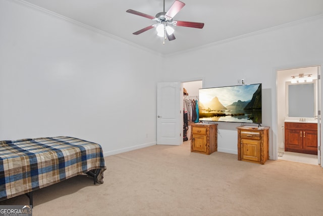 bedroom with ceiling fan, connected bathroom, a walk in closet, a closet, and light carpet