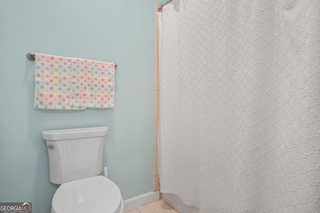 bathroom with walk in shower, tile patterned floors, and toilet