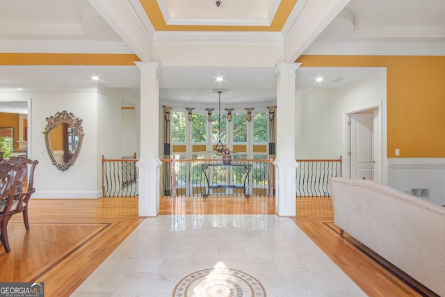 hallway featuring ornamental molding, beam ceiling, and light hardwood / wood-style flooring