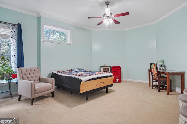 carpeted bedroom with ceiling fan and crown molding