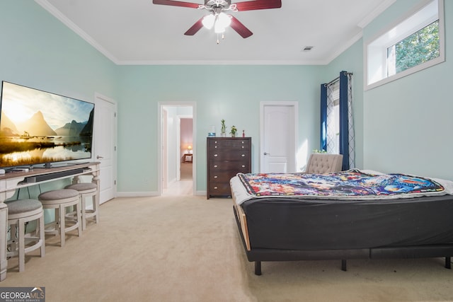 carpeted bedroom featuring crown molding and ceiling fan