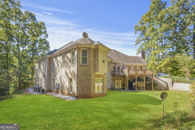 1565 Mountain Shadow Trl, Stone Mountain, GA 30087 - back of property with a chimney, stairs, a wooden deck, a lawn, and brick siding