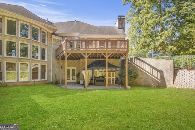 1565 Mountain Shadow Trl, Stone Mountain, GA 30087 - rear view of property featuring a yard, french doors, a chimney, and a deck