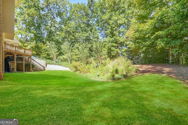 view of yard featuring a wooden deck