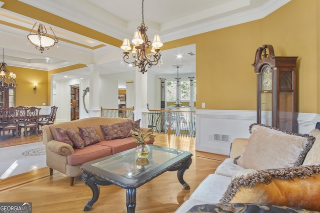 1565 Mountain Shadow Trl, Stone Mountain, GA 30087 - living room with a raised ceiling, wood finished floors, visible vents, crown molding, and a chandelier
