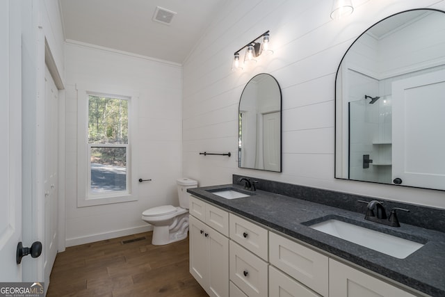 bathroom featuring a shower, toilet, wood-type flooring, vaulted ceiling, and vanity