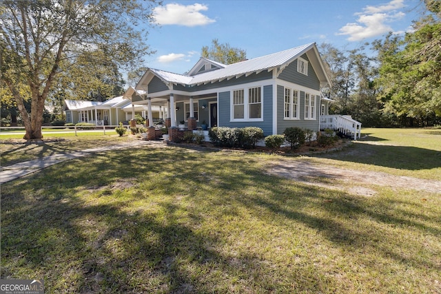 view of front of property with a porch and a front lawn