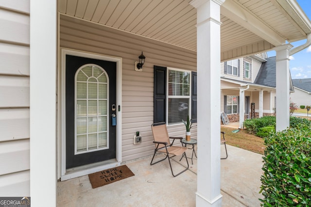 view of exterior entry with a porch