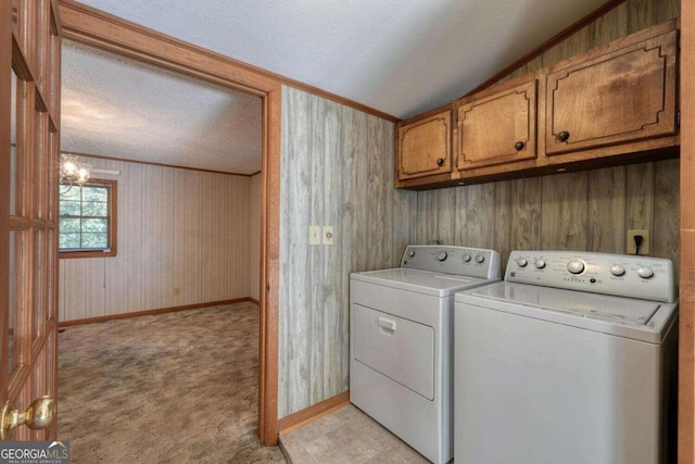 laundry area featuring ornamental molding, a textured ceiling, cabinets, independent washer and dryer, and light colored carpet