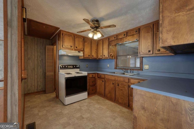 kitchen featuring white electric range oven, ceiling fan, sink, and a textured ceiling