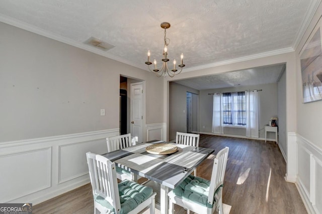 dining space featuring hardwood / wood-style flooring and a textured ceiling