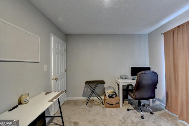 carpeted office featuring a textured ceiling