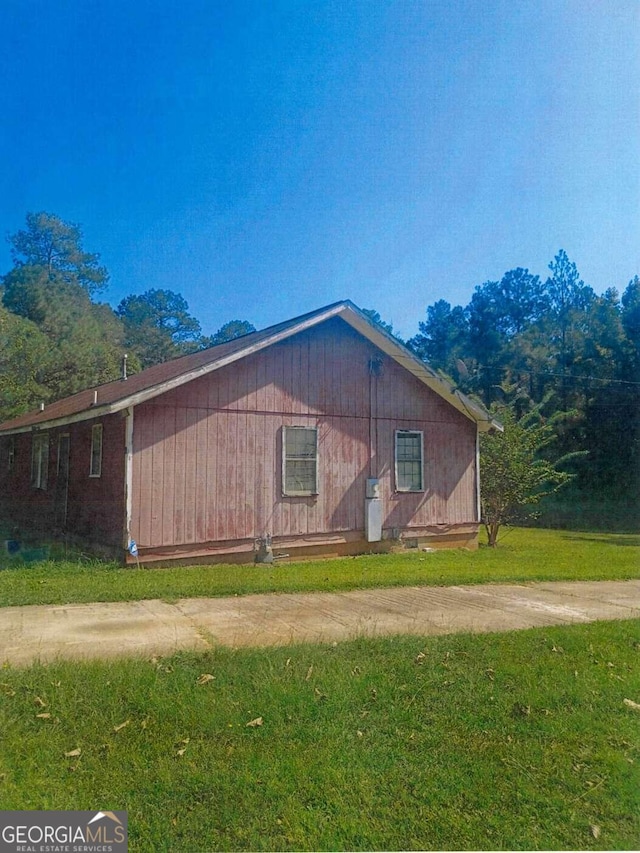 view of property exterior featuring a lawn