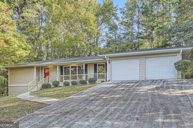 ranch-style house with a porch and a garage