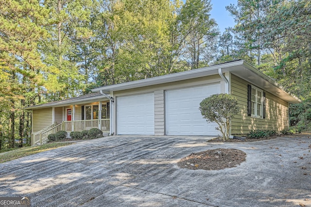 view of front of home featuring a garage and a porch