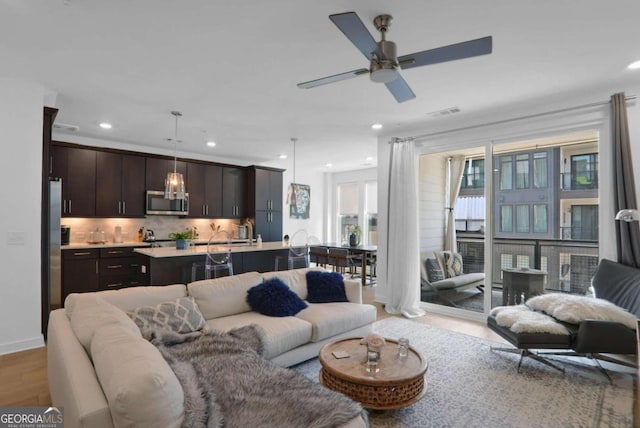 living room with ceiling fan and wood-type flooring