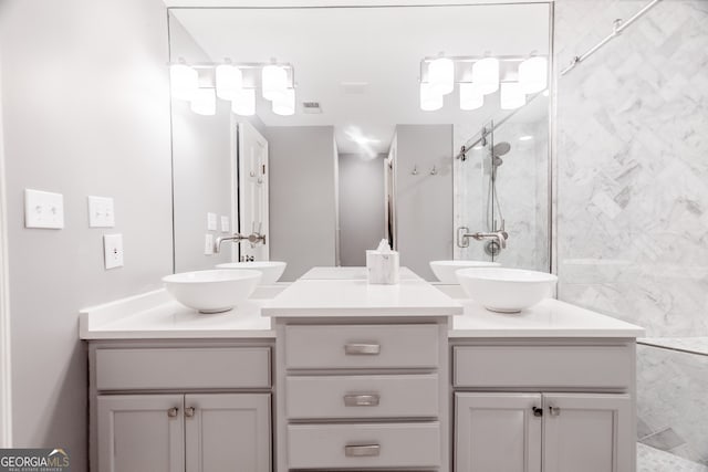 bathroom with vanity and tiled shower