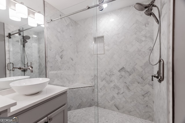 bathroom featuring vanity and a shower with shower door