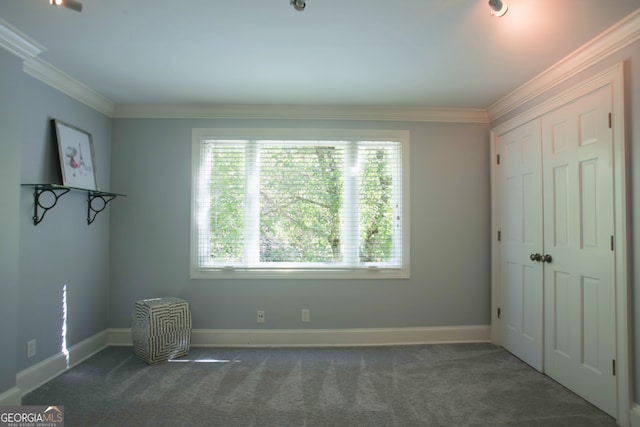 unfurnished bedroom featuring dark carpet, a closet, and crown molding