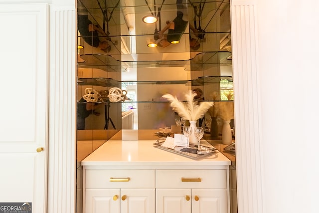 bar featuring white cabinets