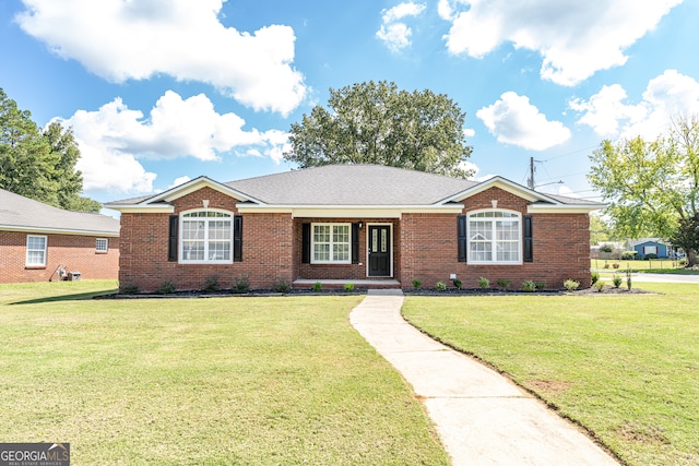 ranch-style home featuring a front yard