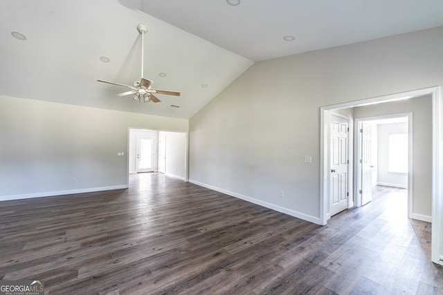 spare room featuring dark wood-type flooring, plenty of natural light, high vaulted ceiling, and ceiling fan