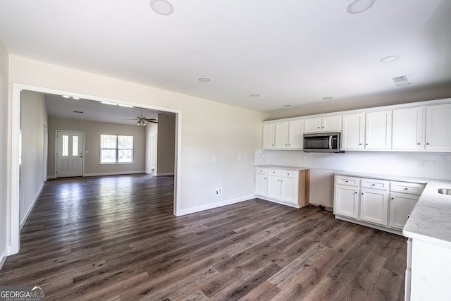 kitchen with ceiling fan, dark hardwood / wood-style flooring, and white cabinetry